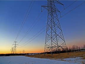 Dawn breaks in beautiful colours over power-lines near Manning Drive and 18 St., in Edmonton, Alta., on Saturday Jan. 2, 2016.