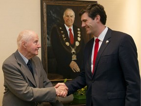Former Edmonton mayor Terry Cavanagh, left, shakes hands with Mayor Don Iveson in the newly renamed Cavanagh Room at the Fairmont Hotel Macdonald on Wednesday, May 13, 2015.