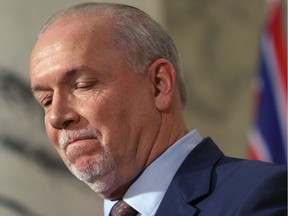 Premier John Horgan is joined by Minister of Energy Michelle Mungall and Minister of Environment George Heyman after giving the green light on continuing construction on the controversial Site C Dam project during a press conference in Victoria, B.C., on Monday, December 11, 2017.