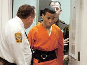 FILE - In this Oct. 26, 2004, file photo, Lee Boyd Malvo enters a courtroom in the Spotsylvania, Va., Circuit Court. A federal judge has tossed out two life sentences for D.C. sniper shooter Lee Boyd Malvo and ordered Virginia courts to hold new sentencing hearings. In a ruling issued Friday, U.S. District Judge Raymond Jackson in Norfolk said Malvo is entitled to new sentencing hearings after the U.S. Supreme Court ruled that mandatory life sentences for juveniles are unconstitutional. (Mike Morones/The Free Lance-Star via AP) ORG XMIT: VAFRE201