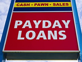 A sign advertising payday loans is seen at Cash Canada in Edmonton, Alta., on Oct. 7, 2015.