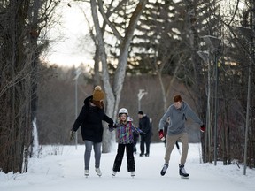 Michelle Nelson ice skates with her children Veronica Nelson, 8, and Spencer Nelson, 14, along the IceWay in Victoria Park in Edmonton Wednesday, Jan. 3, 2018.