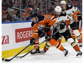 The Edmonton Oilers' Jesse Puljujarvi (98) battles the Anaheim Ducks' Logan Shaw (48) at Rogers Place in Edmonton on Thursday, Jan. 4, 2018. (David Bloom)