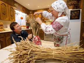Roman Petriw and his wife Lessia Petriw work on a Christmas decoration called a Didukh, as they prepare traditional Ukrainian Christmas dinner at their home in Edmonton Saturday, Jan. 6, 2018.
