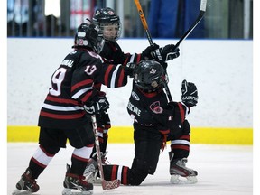 Scott Erskine of the SWAT Ghostbusters, right, celebrates his game-winning goal against the KC Southside Golden Knights during Minor Hockey Week action at the Terwillegar Arena on Jan. 14, 2018.