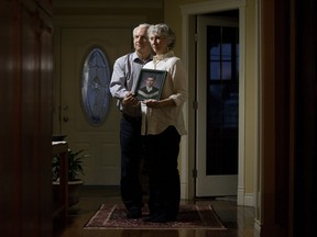 Kathryn and Ken Fearnley hold a portrait of their son Joshua Stebbins. The 46-year-old University of Alberta grad was killed in Asheville, N.C., in June 2017.