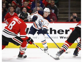 Edmonton Oilers forward Ryan Nugent Hopkins looks to pass in front of Nick Schmaltz of the Chicago Blackhawks at the United Center on Sunday, Jan. 7, 2018, in Chicago.