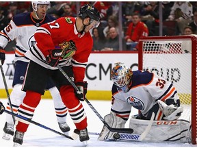 Cam Talbot #33 of the Edmonton Oilers makes a save against Lance Bouma #17 of the Chicago Blackhawks at the United Center on January 7, 2018 in Chicago, Illinois.