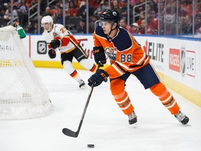 EDMONTON, AB - JANUARY 25: Brandon Davidson #88 of the Edmonton Oilers skates against Dougie Hamilton #27 of the Calgary Flames at Rogers Place on January 25, 2018 in Edmonton, Canada.