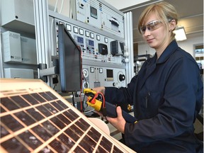 Student Csilla Harsasi on the solar PV trainer in the Alternative Energy Technologist program at NAIT, where students leave this highly technical program ready for a career in renewable energy in Edmonton, September 26, 2017.
