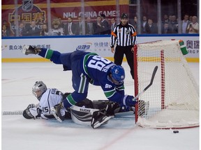 Los Angeles Kings' goalkeeper Darcy Kuemper stop a shot by Vancouver Canucks' Sam Gagner during the shoot-out (up) at the 2017 NHL China Games in Beijing on September 23, 2017. The Los Angeles Kings and Vancouver Canucks face each other during a preseason game played in China in the 2017 NHL China Games.