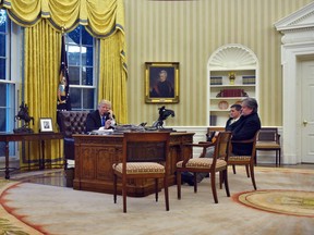 Trump in his office alongside former Chief Strategist Steve Bannon and former National Security Advisor Michael Flynn, from the Oval Office in January 2017.