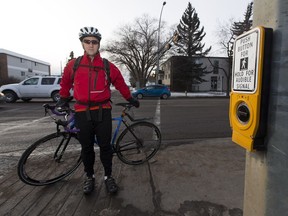 Darcy Reynard now uses his phone or watch to time beg buttons on his route, helping to populate his crowd-sourced map with data on waiting times across Edmonton. He's pictured here at a beg button at 149 Street and 91 Avenue on Tuesday, Jan. 23, 2018.