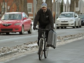 A bicyclist rides on a designated bicycle lane on 102 Avenue near 117 Street in downtown Edmonton on Monday Nov.27, 2017.