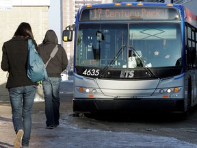 File: Transit users board a bus at the Southgate transit terminal.