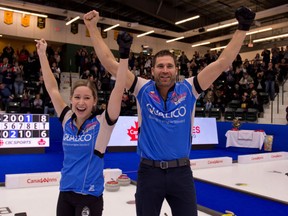 The pair of Kaitlyn Lawes and John Morris raise their arms in victory after an 8-6 win over the pair of Val Sweeting and Brad Gushue in the final of the mixed doubles curling trials in Portage la Prairie, Man. on Sunday. By virtue of the win, the pair will represent Canada at the Olympic Games next month in PyeongChang, South Korea.