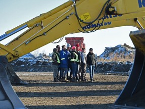 Some of the women graduates stand with the heavy equipment they were trained on at High Velocity Heavy Equipment Training College in Edmonton on Friday, Jan. 5, 2018.