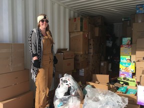True North Aid supporter Bethany Diefenbaker helps load donations into a shipping container sent to the Onion Lake Cree Nation from Kitchener, Ont.