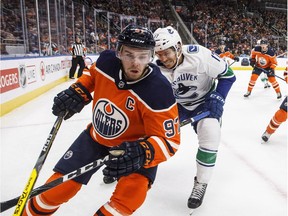 Vancouver Canucks Nic Dowd (17) chases Edmonton Oilers' Connor McDavid (97) during first period NHL action in Edmonton, Alta., on Saturday January 20, 2018.