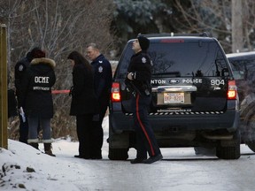 Police investigate a suspicious death in a residential alley near 92 Avenue and 77 Street in southeast Edmonton on Jan. 1, 2018.
