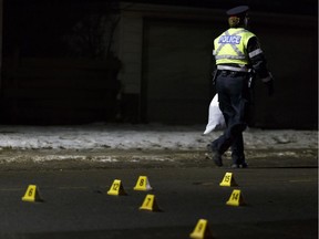 Edmonton Police Service officers investigate a hit and run at 96 Street and 71 Avenue in Edmonton, Alberta on Wednesday, Dec. 13, 2017.