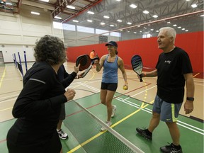 Wendy Schilling, left, Dale Rutter, Cassie Williams and Doug Thomson shake hands after a pickleball game at Terwillegar Recreation Centre in Edmonton, Alta., on Wednesday, Jan. 3, 2018.