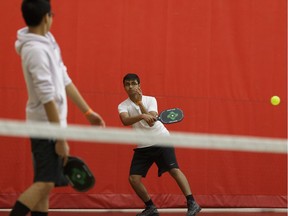 Jason Chen (left) and Atharva Laud play pickleball during a drop-in session at Terwillegar Recreation Centre in Edmonton, Alberta on Wednesday, January 3, 2018.