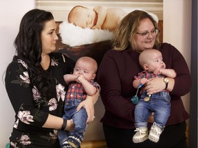 Amber Kent, left, and Health Minister Sarah Hoffman hold Kent's sons Caellum and Bodie on Monday during a news conference in St. Albert on Monday, Jan. 15, 2018 to announce a new neonatal intensive care unit for the Sturgeon Community Hospital.