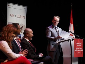 Citadel artistic director Daryl Cloran at the podium of a news conference Tuesday. From left, the Citadel's new executive director, Chantell Ghosh, Amarjeet Sohi and Randy Boissonnault.