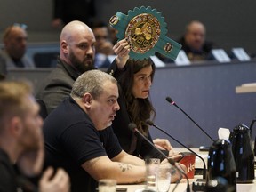 Boxer Jelena Mrdjenovich holds up her WBC boxing title belt as she speaks to Edmonton City Council about the ongoing combative sports moratorium during a Community And Public Services Committee meeting at City Hall in Edmonton, Alberta on Wednesday, Jan. 17, 2018.
