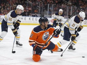Edmonton's Andrej Sekera (2) falls after contact with Buffalo's Kyle Okposo (21) during the first period of an NHL game between the Edmonton Oilers and the Buffalo Sabres at Rogers Place in Edmonton, Alberta on Tuesday, Jan. 23, 2018. Photo by Ian Kucerak Photos for copy in Wednesday, Jan. 24 edition