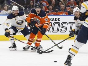 Edmonton's Drake Caggiula (91) looks to Buffalo's Rasmus Ristolainen (55) during the first period of an NHL game between the Edmonton Oilers and the Buffalo Sabres at Rogers Place in Edmonton, Alberta on Tuesday, Jan. 23, 2018. Photo by Ian Kucerak Photos for copy in Wednesday, Jan. 24 edition