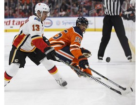 Edmonton Oilers defenceman Darnell Nurse (25) battles Calgary Flames forward Johnny Gaudreau at Rogers Place in Edmonton on Thursday, Jan. 25, 2018. (Ian Kucerak)
