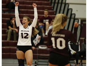 Kylie Schubert (12) celebrates with Zoe Cronin (10) during a Canada West volleyball match between the MacEwan University Griffins and the Regina Cougars in Edmonton, Alberta on Friday, Jan. 26, 2018.