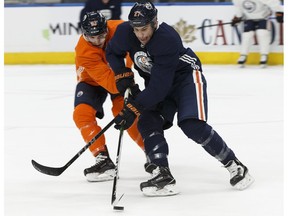 Edmonton's Matt Benning (83) and Milan Lucic (27) drill during an Edmonton Oilers practice at Rogers Place in Edmonton, Alberta on Monday, Jan. 29, 2018.