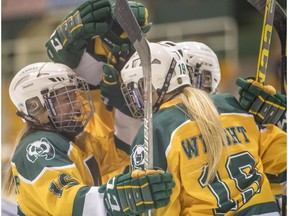 University of Alberta Pandas hockey team forward Alexandra Poznikoff (16) celebrates her goal with Regan Wright (19) and other teammates in a 1-0 win against the University of Lethbridge Pronghorns at Clare Drake Arena on Saturday, Jan. 27, 2018.