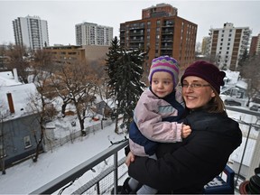 Heather MacKenzie holds her daughter Grace, 3, on her Oliver neighbourhood balcony. City planers are hoping a new incentive program will encourage more family-sized units in core neighbourhoods.