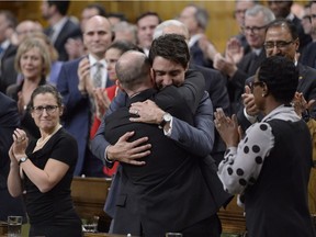 Prime Minister Justin Trudeau hugs Liberal MP Randy Boissonnault after making a formal apology to individuals harmed by federal legislation, policies, and practices that led to the oppression of and discrimination against LGBTQ2 people in Canada, in the House of Commons in Ottawa, Tuesday, Nov.28, 2017.
