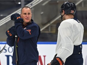 Former Oilers defenceman Paul Coffey talks with Leon Draisaitl during a practice at Rogers Place in Edmonton, Jan. 24, 2018.