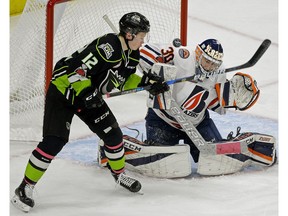 Kamloops Blazers goalie Max Palaga makes a save on Edmonton Oil Kings' Liam Keeler (12) in Edmonton on Sunday Jan. 21, 2018.