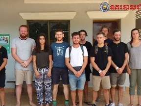 In this photo dated Jan. 27, 2018, issued by Cambodian National Police, a group of foreigners stand after they were arrested for "dancing pornographically" at a party in Siem Reap town, near the country's famed Angkor Wat temple complex. Police said on Sunday, Jan. 28, 2018, they raided a rented villa on Thursday and found people "dancing pornographically," and while almost 90 foreigners were detained, all but 10 were released. Five British nationals, two Canadians, one Norwegian, one New Zealander and one from the Netherlands are being held.