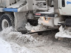 A snow plow heads up Gateway Blvd.