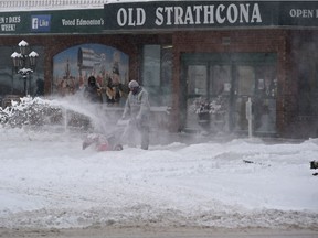 Workers clearing snow along Gateway Blvd., as a snow storm moved the city and they will declare seasonal parking bans over the weekend in Edmonton, January 26, 2018. Ed Kaiser/Postmedia