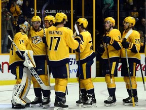 The Nashville Predators line up to congratulate goalie Juuse Saros (74) after his shutout against the Minnesota Wild in an NHL hockey game on Dec. 30, 2017, in Nashville, Tenn.