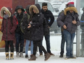 Students wait for a transit bus near MacEwan University In downtown Edmonton on Tuesday January 9, 2018. Environment Canada issues an extreme cold warning for Edmonton on Wednesday afternoon.