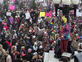 People take part in a rally at the Alberta legislature on Jan. 21, 2017. The event was in support of a Washington march for women's rights to protest the inauguration of U.S. President Donald Trump.