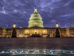 FILE - In this Jan. 21, 2018, file photo, lights shine inside the U.S. Capitol Building as night falls in Washington. President Donald Trump will herald a robust economy and push for bipartisan congressional action on immigration in his Jan. 30, State of the Union address. The speech marks the ceremonial kick-off of Trump's second year in office and is traditionally a president's biggest platform to speak to the nation.