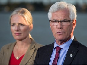 Jim Carr, right, Minister of Natural Resources, speaks as Catherine McKenna, Minister of Environment and Climate Change, listens after the federal government announced approval of the Pacific NorthWest LNG project, at the Sea Island Coast Guard Base in Richmond, B.C., on Tuesday September 27, 2016.