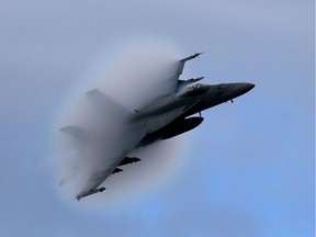 An F-18 Super Hornet creates a vapour cone as it flies at a transonic speed.