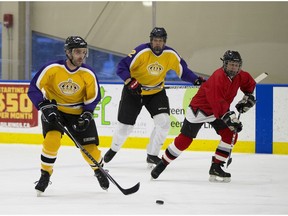 Crown team players in yellow compete against defence team players in red at the fifth annual Crown vs. Defence Charity Hockey Game at Rogers Downtown Community Rink on Saturday, Feb. 3, 2018 in support of the Right to Play program.